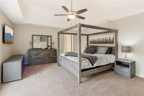 a bedroom with a bed and a chandelier