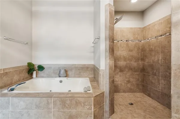 a bathroom with a bathtub and shower