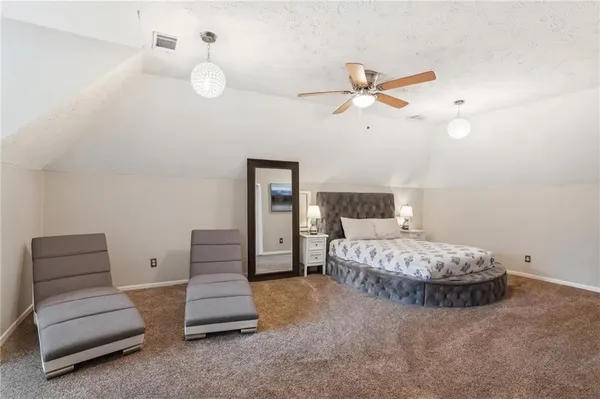 a spacious bedroom with a bed and a couch