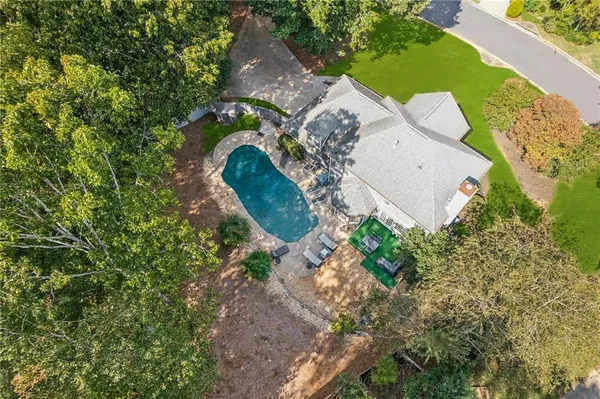 an aerial view of a house with a swimming pool and garden