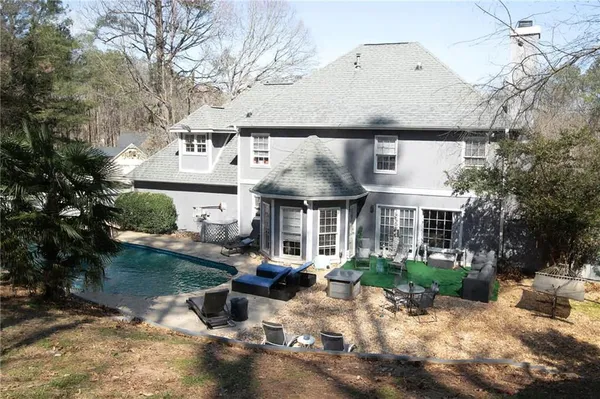 a view of a house with backyard porch and sitting area