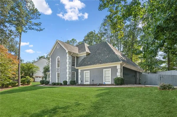 a front view of house with yard and green space