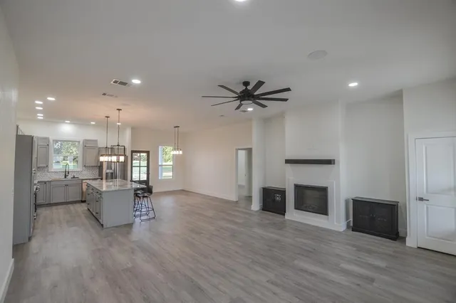 a living room with furniture and kitchen view