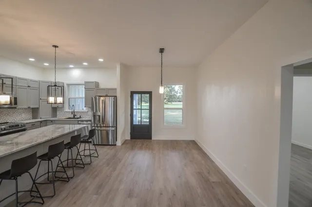 a large kitchen with a table and chairs