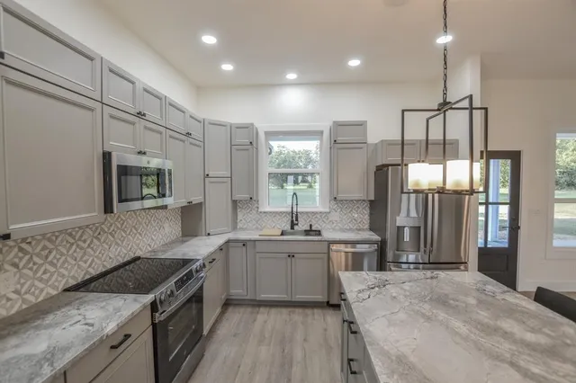 a kitchen with a sink stove and refrigerator