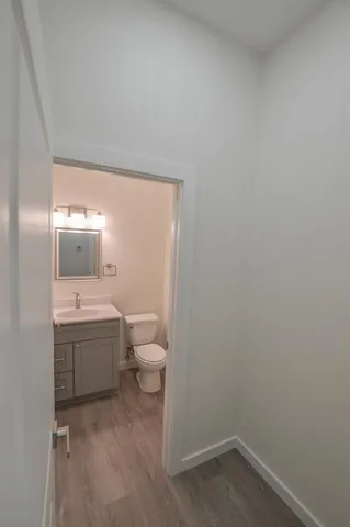 a bathroom with a granite countertop toilet and sink