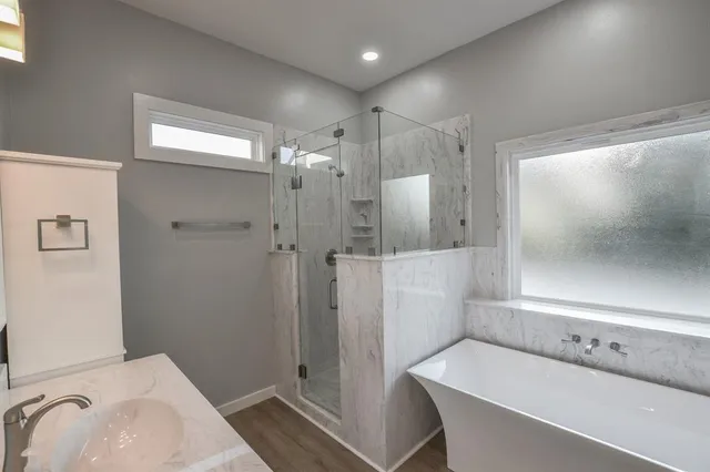 a bathroom with a sink a toilet and shower