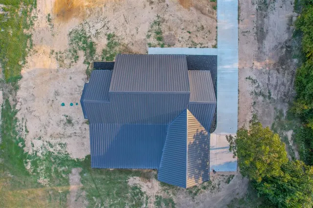 an aerial view of a house with a yard