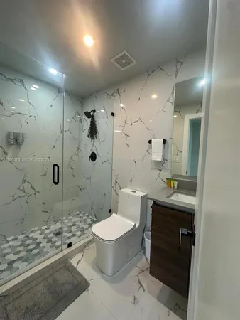 a spacious bathroom with a sink toilet and shower