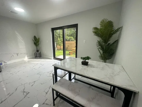 a view of a workspace with a table and chair in a room