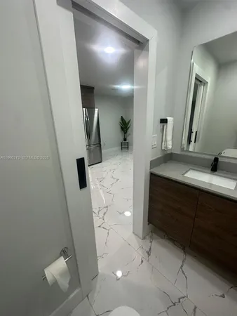 a bathroom with a sink a toilet and mirror