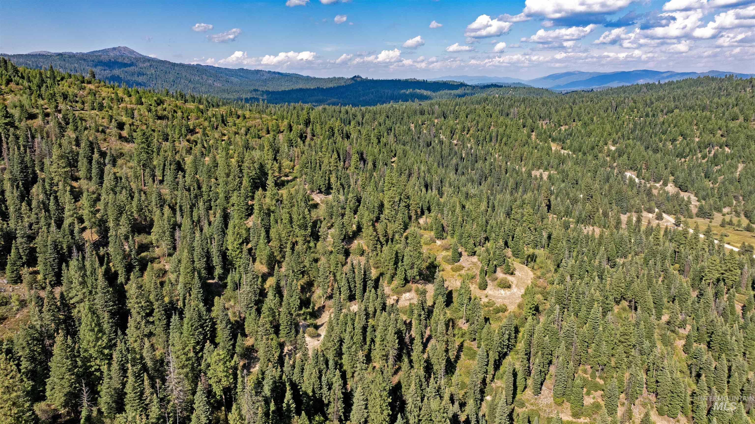 2 High Valley Road Cascade, ID 83611 - Photo 11 of 18 Aerial view of a mountain backdrop and a heavily wooded area
