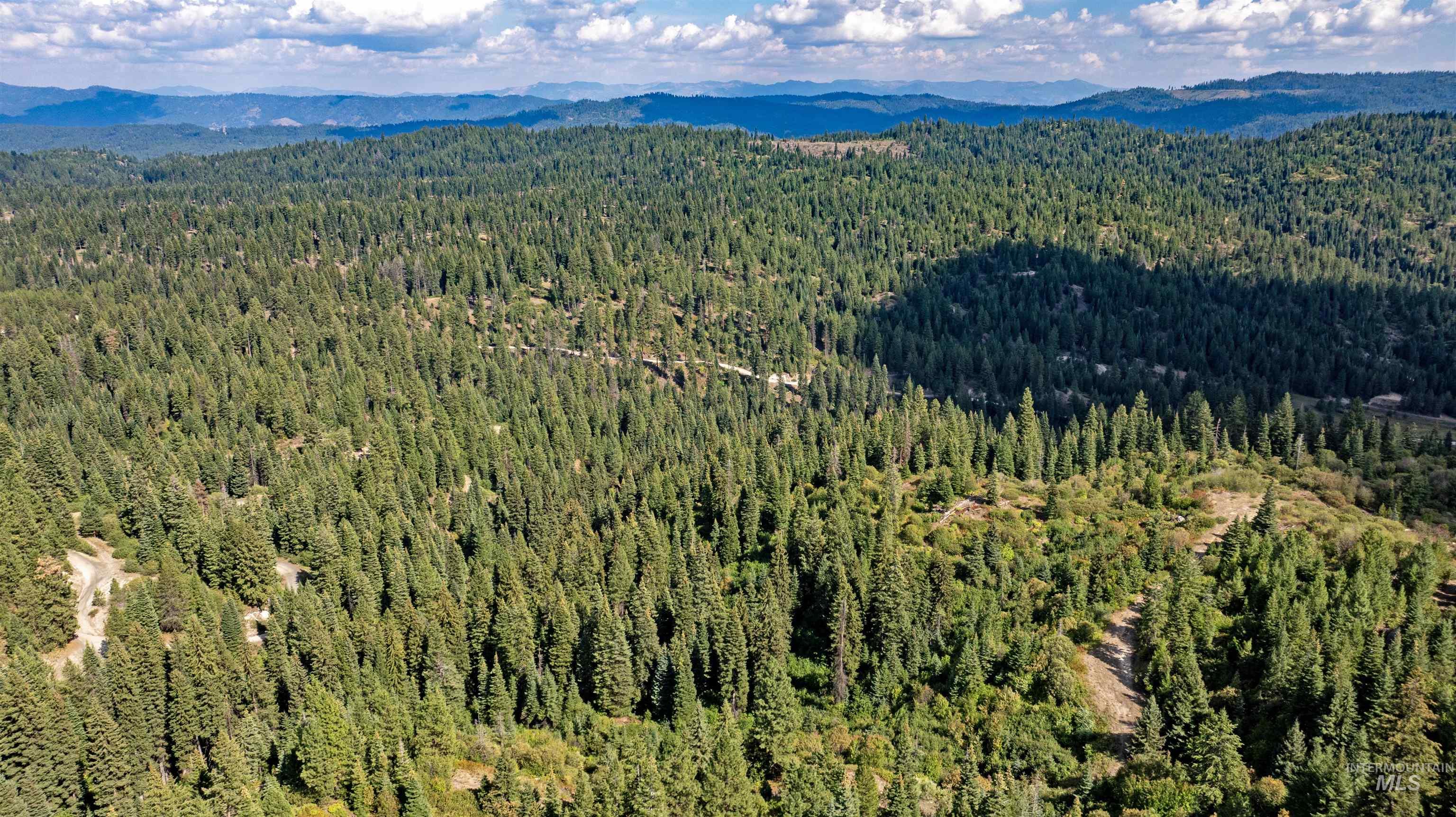 2 High Valley Road Cascade, ID 83611 - Photo 5 of 18 Aerial view of a heavily wooded area and mountains