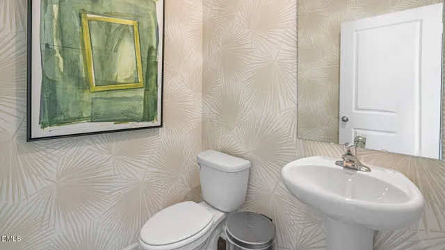 a bathroom with a toilet a sink and a mirror