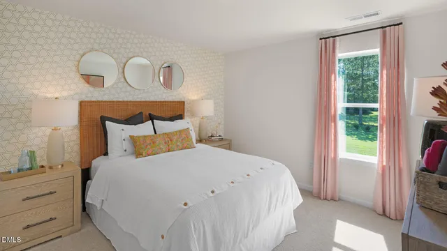 a large bed sitting in a bedroom next to a window