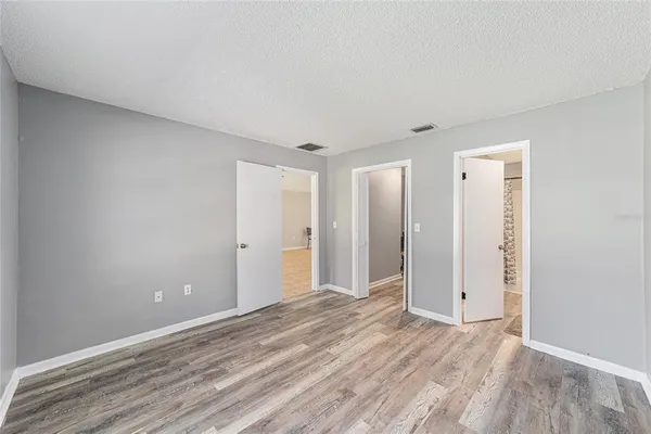 a view of a livingroom with wooden floor and window