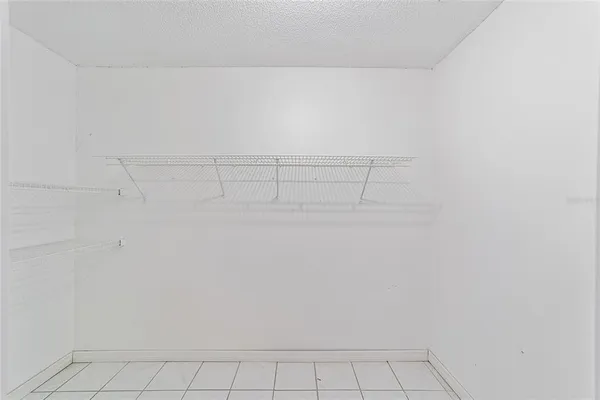 a view of an empty room and wooden floor