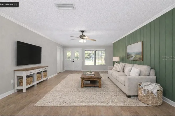 a living room with furniture and a flat screen tv