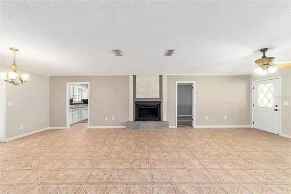 a view of an empty room with a fireplace