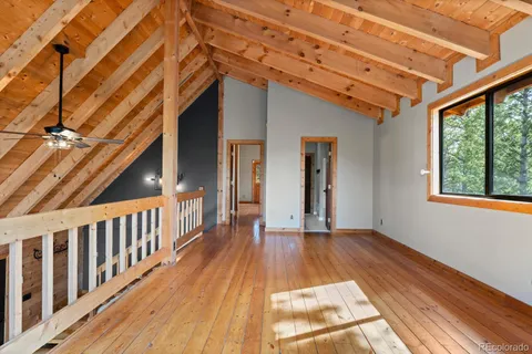 a view of outdoor space with wooden floor and windows