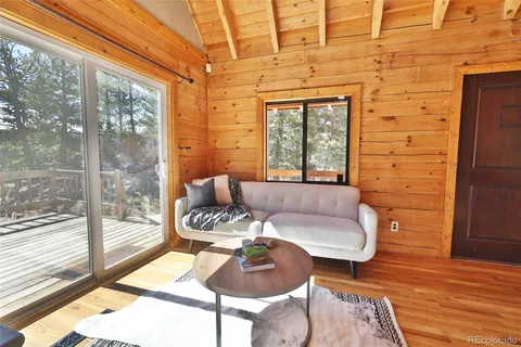 a living room with furniture and a floor to ceiling window