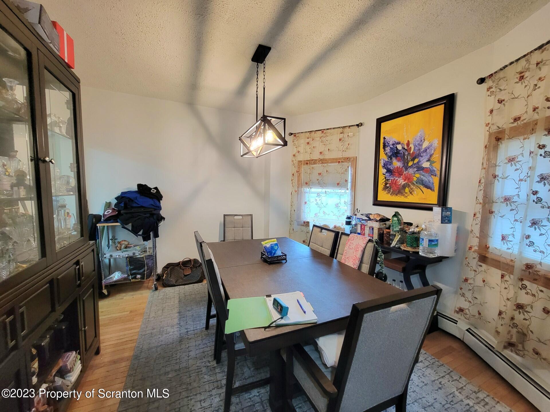 1620 Myrtle Street Scranton, PA 18510 - Photo 16 of 29 a view of a dining room with furniture a chandelier and wooden floor