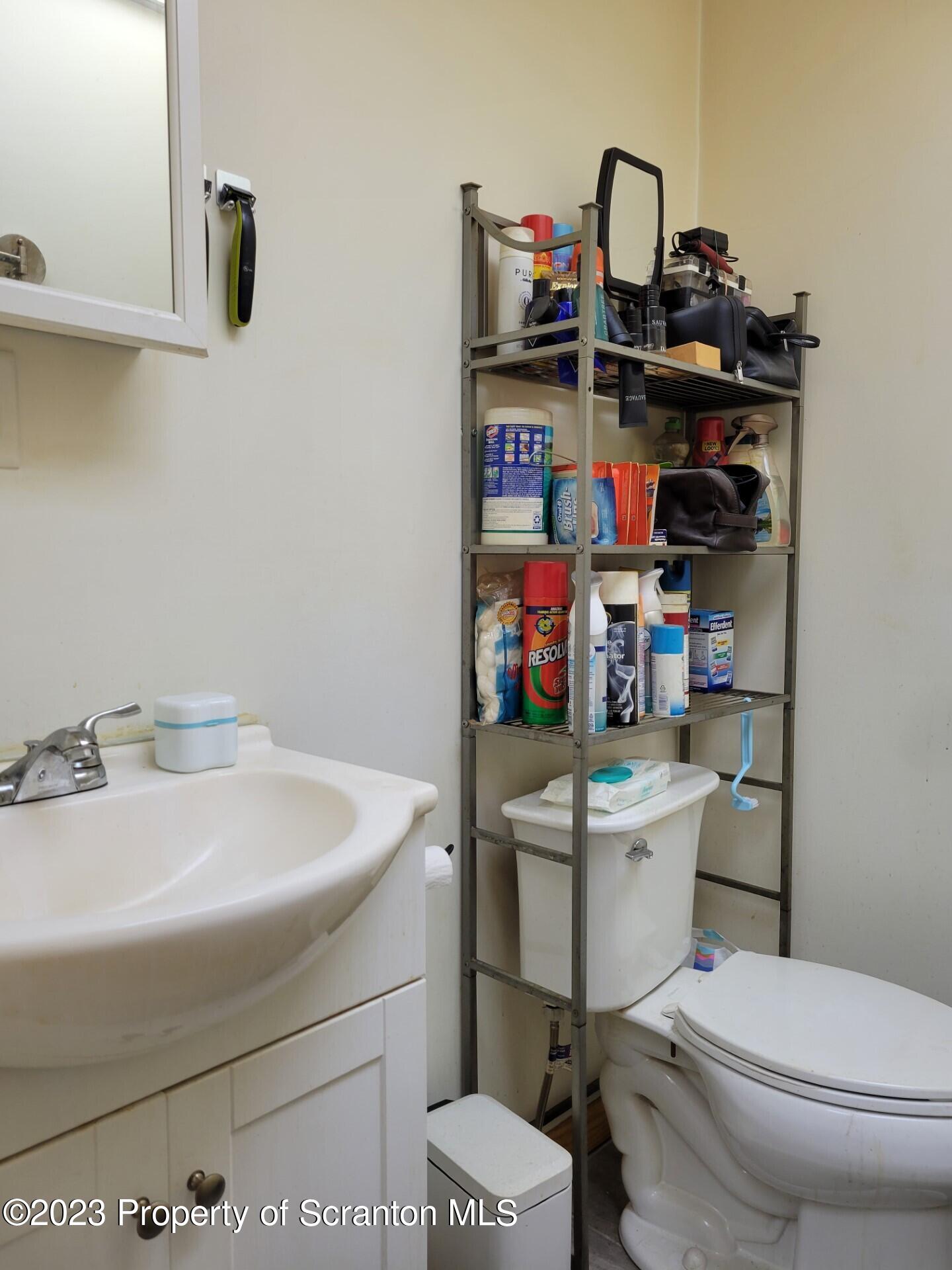1620 Myrtle Street Scranton, PA 18510 - Photo 18 of 29 a bathroom with a sink a toilet and a wooden floor