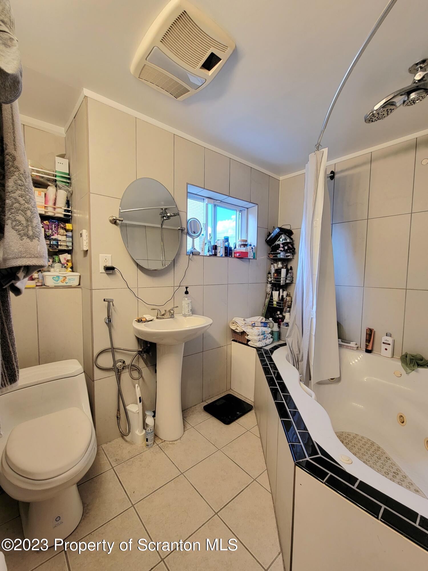1620 Myrtle Street Scranton, PA 18510 - Photo 21 of 29 a bathroom with a sink a toilet and a mirror