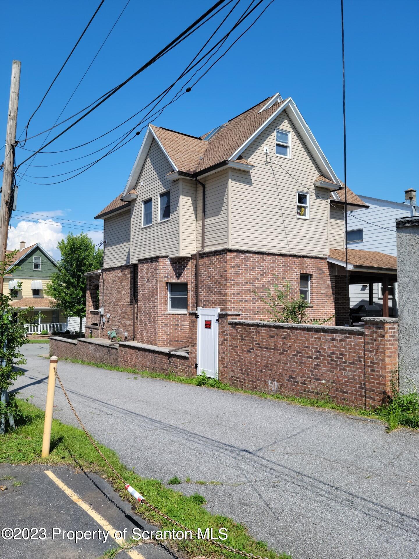 1620 Myrtle Street Scranton, PA 18510 - Photo 5 of 29 a front view of a house with a yard