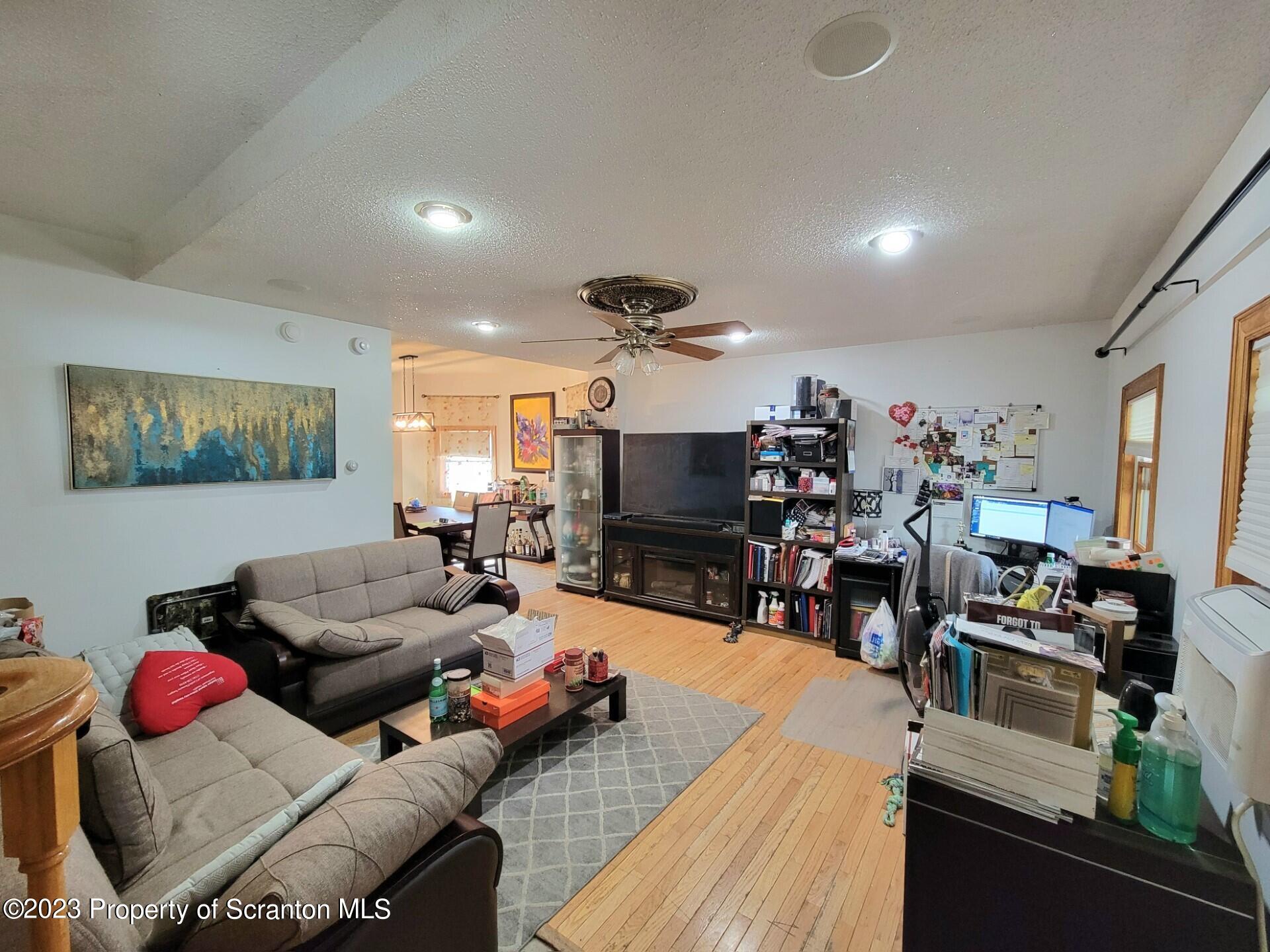 1620 Myrtle Street Scranton, PA 18510 - Photo 9 of 29 a living room with furniture kitchen area and a flat screen tv
