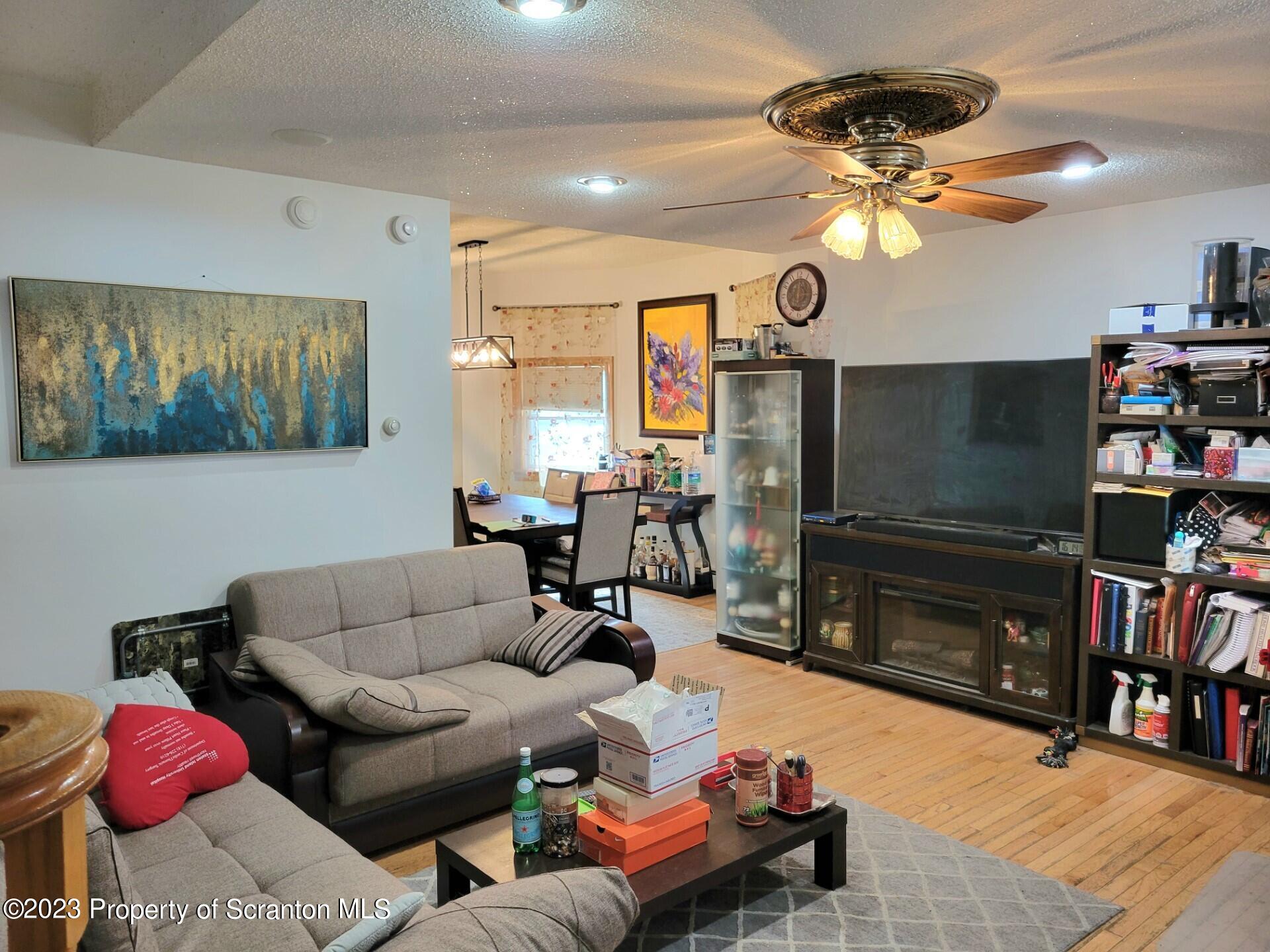 1620 Myrtle Street Scranton, PA 18510 - Photo 10 of 29 a living room with furniture a flat screen tv and a dining table