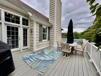a view of outdoor sitting area with furniture and wooden floor