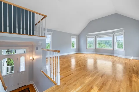 a view of an entryway with wooden floor