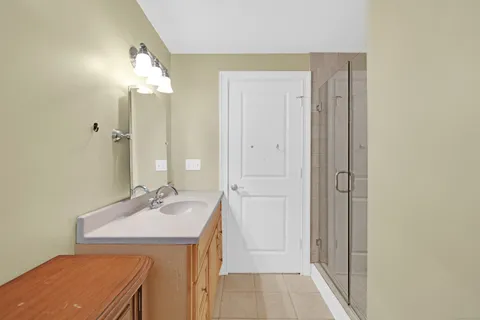 a bathroom with a sink a mirror and a shower