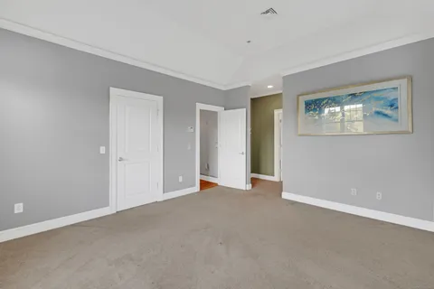 a view of an empty room with a painting