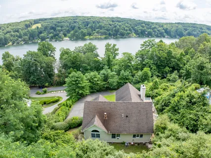 an aerial view of a house with yard and outdoor seating