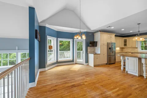a view of a kitchen with refrigerator and cabinets