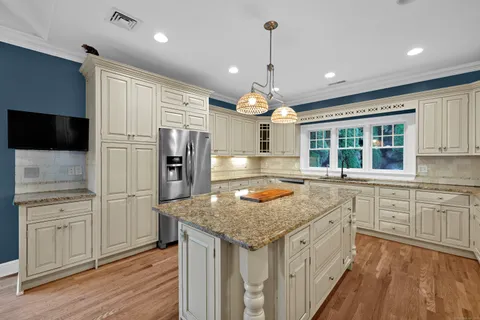 a kitchen with stainless steel appliances granite countertop a sink and a stove