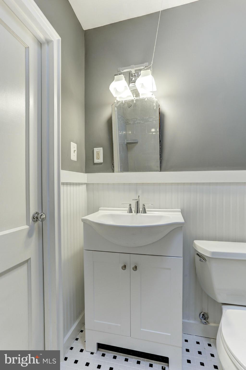 938 Coleridge Road Baltimore, MD 21229 - Photo 14 of 27 a bathroom with a sink and a mirror