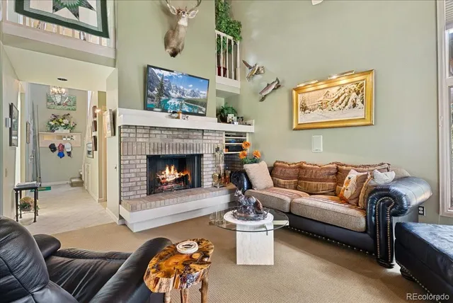 a living room with furniture a fireplace and a wall painting