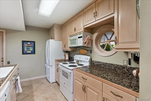 a kitchen with stainless steel appliances granite countertop a refrigerator and a stove