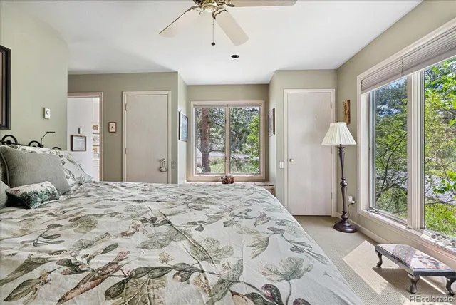 a bedroom with a large bed and a window