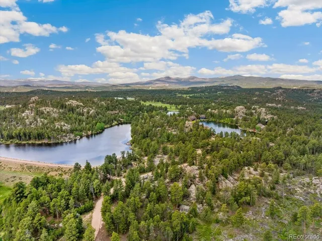 a view of a lake with houses in the back