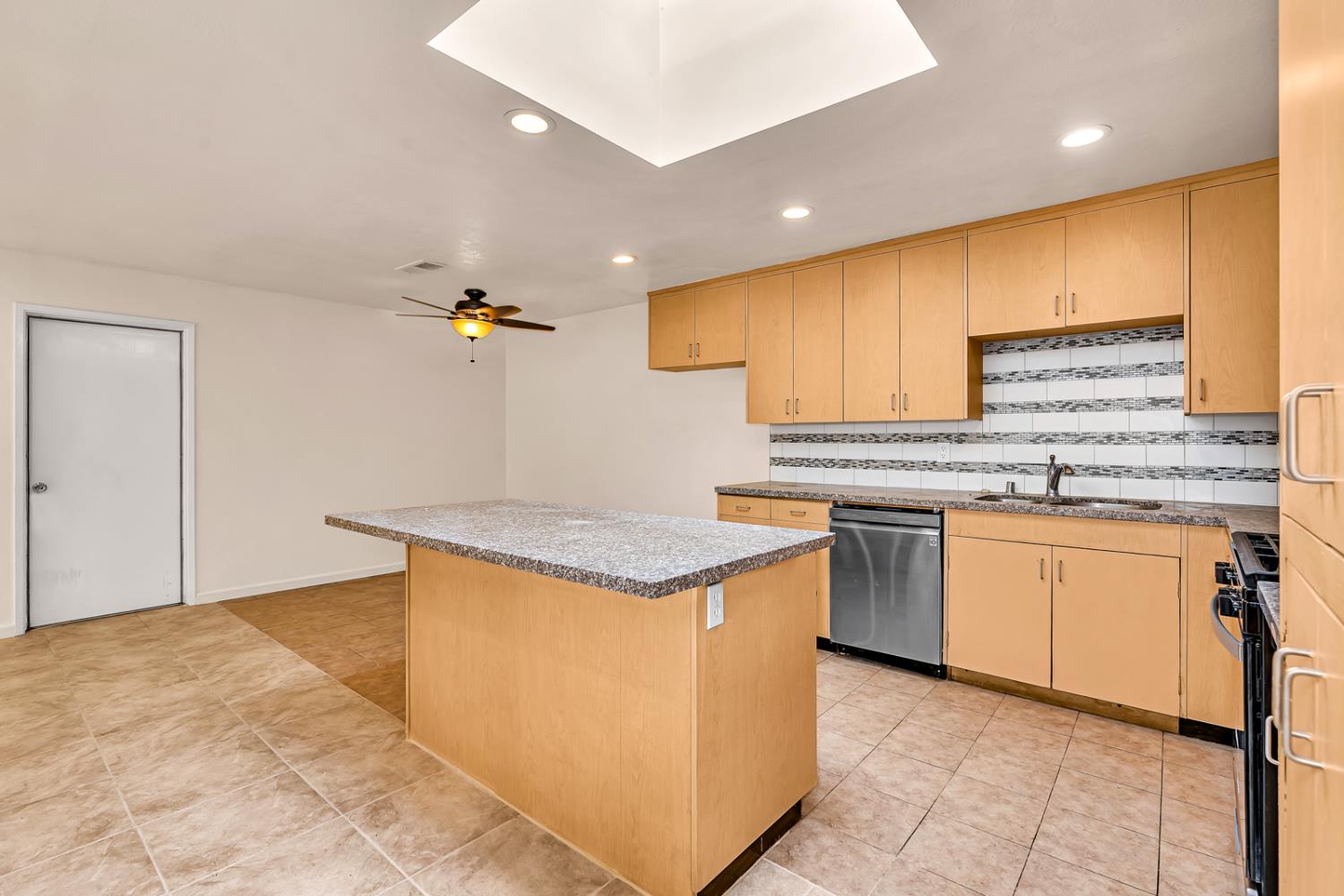 200 Dorita Way Modesto, CA 95354 - Photo 18 of 37 a kitchen with granite countertop a sink a stove top oven and cabinets