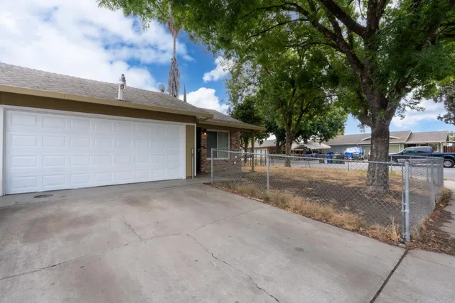 a view of a street with a tree