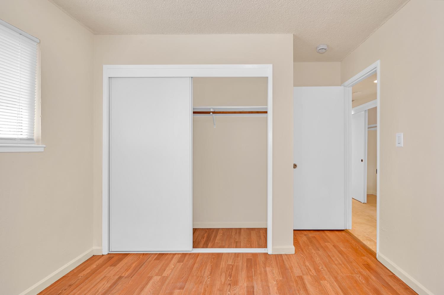 200 Dorita Way Modesto, CA 95354 - Photo 25 of 37 an empty room with wooden floor and a window