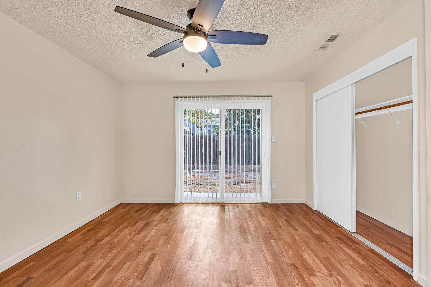 200 Dorita Way Modesto, CA 95354 - Photo 29 of 37 an empty room with wooden floor and windows