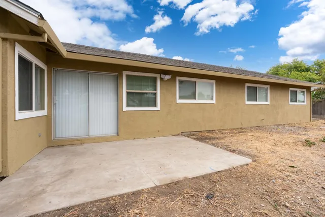 a house that has a tree in front of it