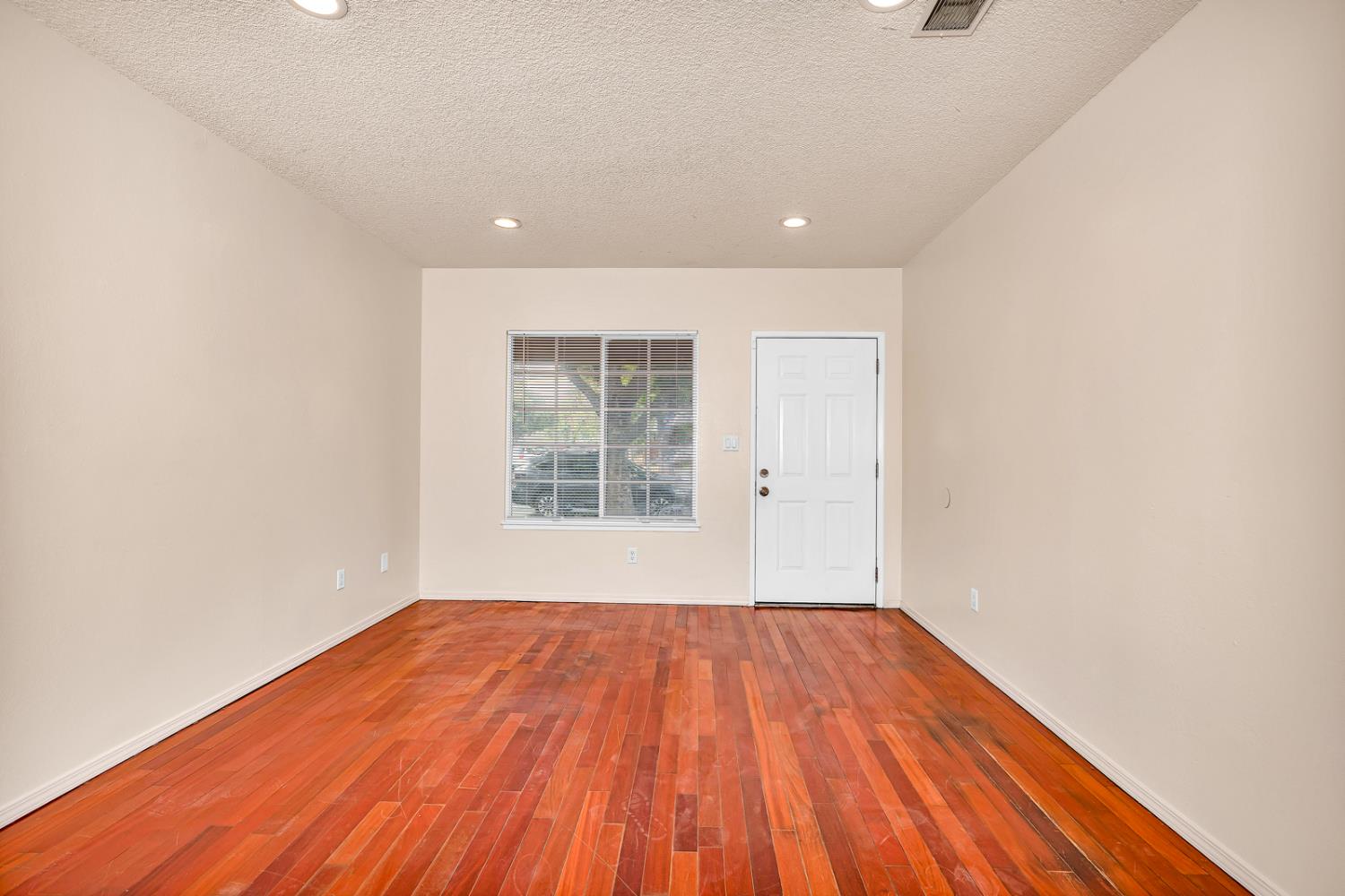 200 Dorita Way Modesto, CA 95354 - Photo 8 of 37 a view of an empty room with wooden floor and a window
