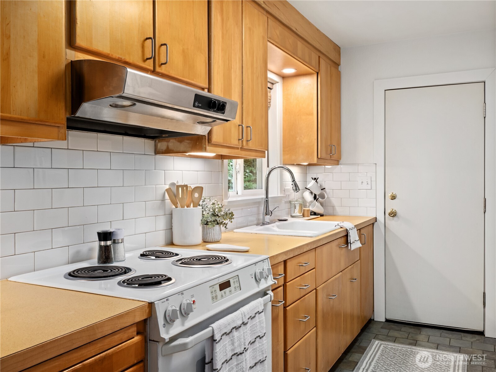 11640 59th Avenue South Seattle, WA 98178 - Photo 19 of 33 a kitchen with a sink stove and cabinets